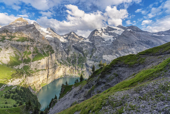 Hikers walks around lake Oeschinensee Bernese Oberland Kandersteg Canton of Bern Switzerland Europe