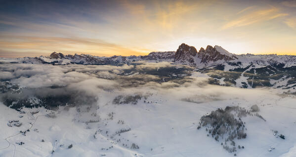 Aerial views of the Alpe di Siusi (Seiser Alm) with the peaks of Sassolungo and Sassopiatto on sunrise, Dolomiti, South Tyrol, Bolzano Province, Italy