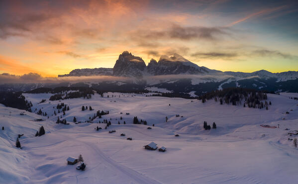 Aerial views of the Alpe di Siusi (Seiser Alm) with the peaks of Sassolungo and Sassopiatto on sunrise, Dolomiti, South Tyrol, Bolzano Province, Italy