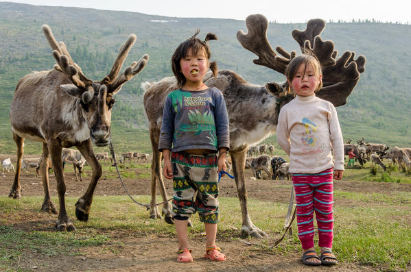 Two Tsaatan girls with their reindeer, Tsaatan Camp, Hovsgol Province, Northern Mongolia.