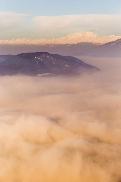 Rosa mount and Spina Verde rise up from a sea of clouds at sunrise. View from Brunate, Como province, Lombardy, Italy, Europe