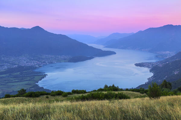Sunrise on lake Como (Alto Lario) with Domaso, Colico and Legnoncino mount on the background, from Sorico village. Como province, Lombardy, Italy, Europe