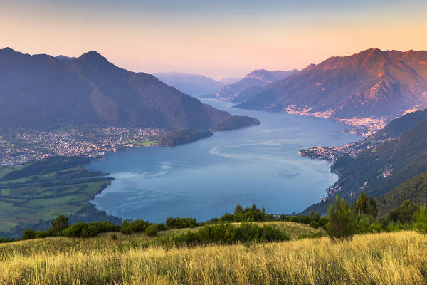 First morning lights on lake Como (Alto Lario) with Domaso, Colico and Legnoncino mount on the background, from Sorico village. Como province, Lombardy, Italy, Europe