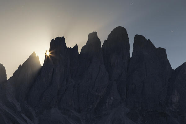 Full moon rises behind the Odle Dolomites (Grande Fermeda, Sass de Mesdì), Funes valley (val di Funes), Bolzano province, South Tyrol, Trentino Alto Adige, Italy, Europe