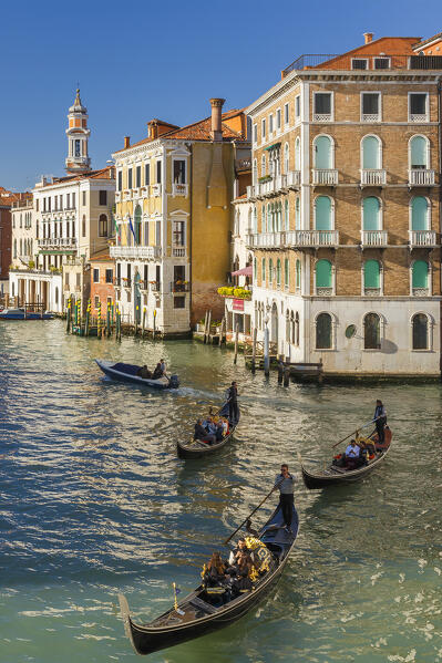 Gondoliers on Grand Canal (Canal Grande), a view from Rialto Bridge (Ponte di Rialto). Venice, Veneto, Italy, Europe