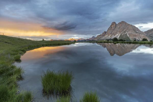 Europe, Italy, South Tyrol, Bolzano. Sunset, rainbow and clouds at the Sass de Putia (Peitlerkofel) from the Wackerer lake, Dolomites