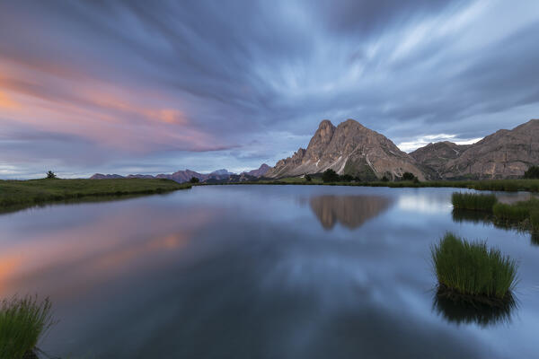 Europe, Italy, South Tyrol, Bolzano. Sass de Putia (Peitlerkofel) at sunset with cloudy sky from the Wackerer lake, Dolomites