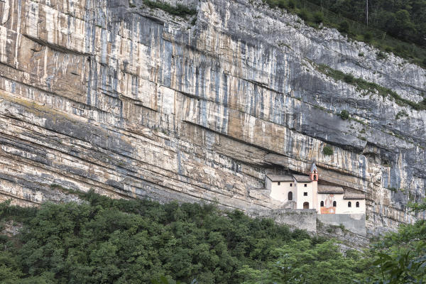 A view of Eremo di San Colombano, a monastery in Trambileno, Province of Trento, Italy, notable for its location in the side of a mountain. 
