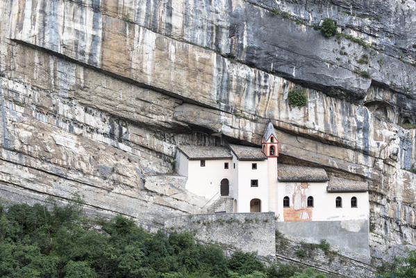 A view of Eremo di San Colombano, a monastery in Trambileno, Province of Trento, Italy, notable for its location in the side of a mountain. 