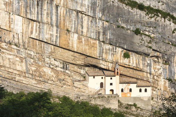 A view of Eremo di San Colombano, a monastery in Trambileno, Province of Trento, Italy, notable for its location in the side of a mountain. 