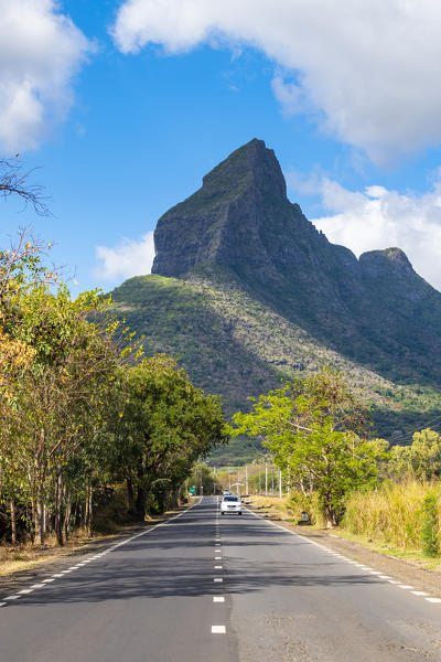 Road with Rempart mountain in the background. Tamarin, Black River (Riviere Noir), Mauritius, Africa