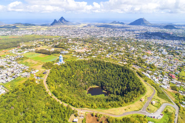 Aerial view of Trou Aux cerfs volcano crater with Curepipe city, Rempart mountain and Trois Mamelles mountain in background. Curepipe, Plaines Wilhems district, Mauritius, Africa