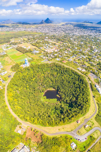 Aerial view of Trou Aux cerfs volcano crater with Curepipe city, Rempart mountain and Trois Mamelles mountain in background. Curepipe, Plaines Wilhems district, Mauritius, Africa