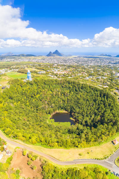 Aerial view of Trou Aux cerfs volcano crater with Curepipe city, Rempart mountain and Trois Mamelles mountain in background. Curepipe, Plaines Wilhems district, Mauritius, Africa