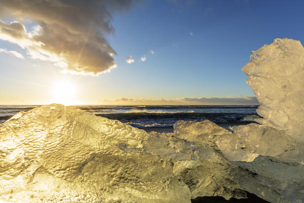 Jokulsarlon, Eastern Iceland, Iceland, Northern Europe. The iconic little icebergs lined on the black sand beach.