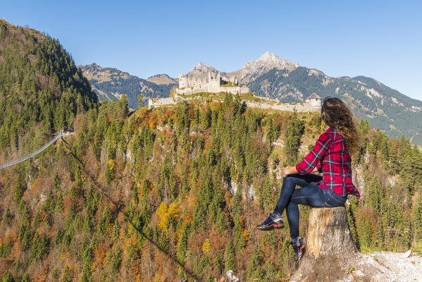 Reutte, Tyrol, Austria, Europe. Ehrenberg Castle and the Highline 179, the world’s longest pedestrian suspension bridge. A young woman admiring the view