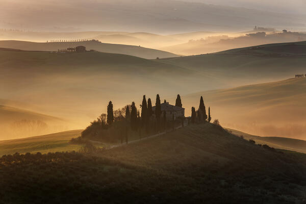 red sunrise in the hills, san Quirico d'orcia, val d'orcia, siena, tuscany, italy