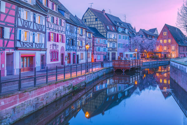Canal waterfront view of traditional townhouses at dusk, Colmar, France
