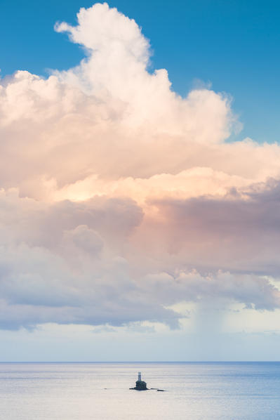 The offshore Tourlitis lighthouse at a cloudy sunset, Andros, Cyclades Archipelago, Greece, Europe