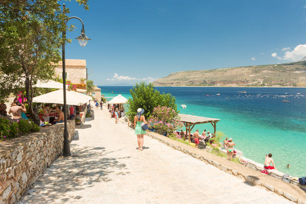 Tourists walking through the enchanting village of Limeni, Mani region, Peloponnese, Greece, Europe