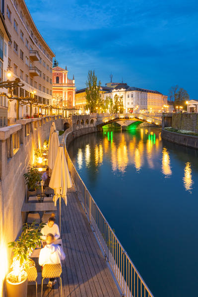 Old town and triple bridge reflected on Ljubljanica river. Ljubljiana, Osrednjeslovenska, Slovenia
