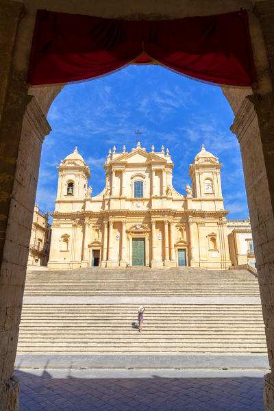 Tourist climbing the stairs of St nicholas church cathedral of Noto, Siracusa province, Sicily, Italy