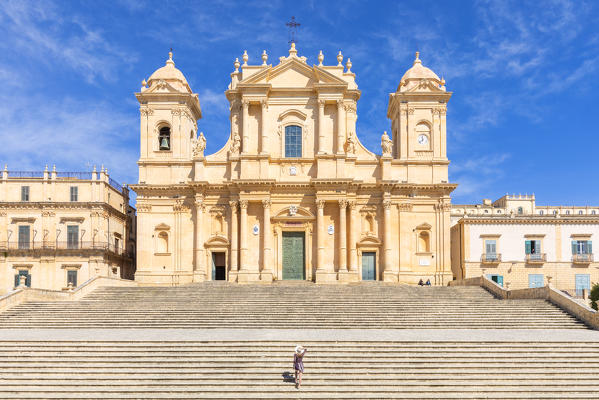 Tourist climbing the stairs of St nicholas church cathedral of Noto, Siracusa province, Sicily, Italy (MR)