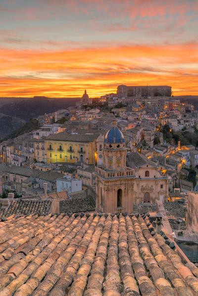 Close up of a typical rooftop with the enchanting hilltop city of Ragusa Ibla in the background at sunrise, Ragusa, Sicily, Italy
