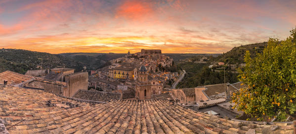 Close up of a typical rooftop with the enchanting hilltop city of Ragusa Ibla in the background at sunrise, Ragusa, Sicily, Italy