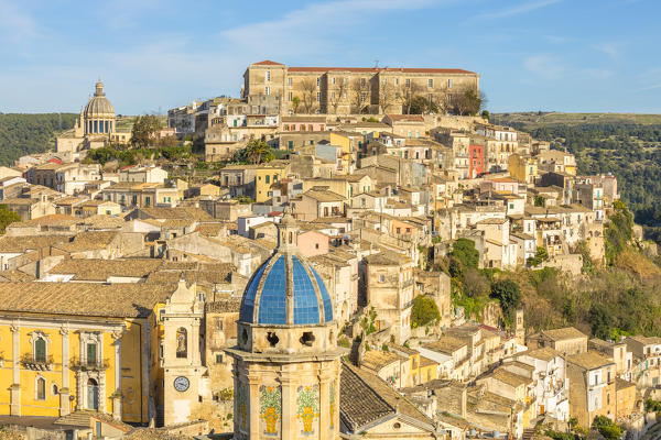 Close up of the dome of Santa Maria dell'Itria church,famous for its coverage of cobalt blue pottery and Ragusa Ibla in the background, Ragusa, Sicily, Italy