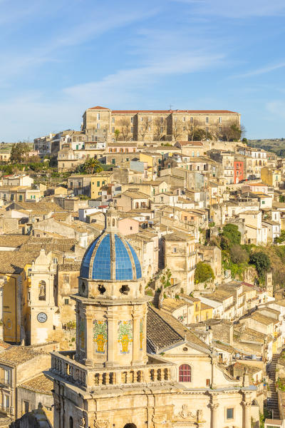 Close up of the dome of Santa Maria dell'Itria church,famous for its coverage of cobalt blue pottery and Ragusa Ibla in the background, Ragusa, Sicily, Italy