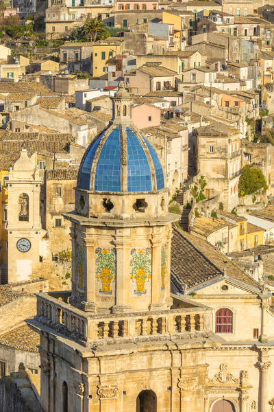 Close up of the dome of Santa Maria dell'Itria church,famous for its coverage of cobalt blue pottery and Ragusa Ibla in the background, Ragusa, Sicily, Italy