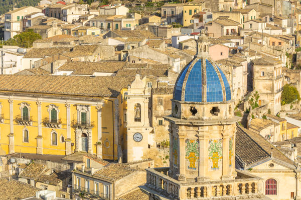 Close up of the dome of Santa Maria dell'Itria church,famous for its coverage of cobalt blue pottery and Ragusa Ibla in the background, Ragusa, Sicily, Italy