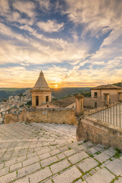 The bell tower of Santa Maria delle scale church and Ragusa Ibla in the background at sunrise, Ragusa, Sicily, Italy