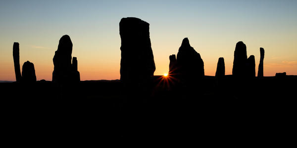 Sunset over standing stones erected in the late Neolithic,Callanish,Isle of Lewis, western scotland,United Kingdom