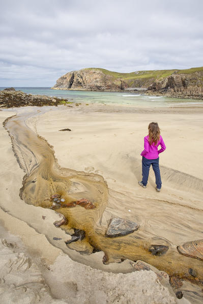 Woman staring at Dailbeag beach, Isle of Lewis, western scotland,United Kingdom