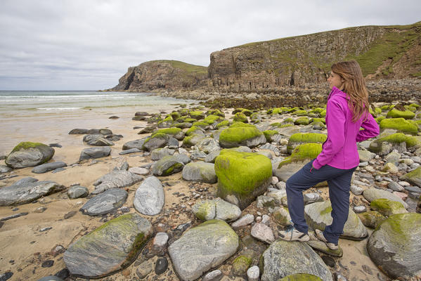 Woman staring at Dailbeag beach, Isle of Lewis, western scotland,United Kingdom

