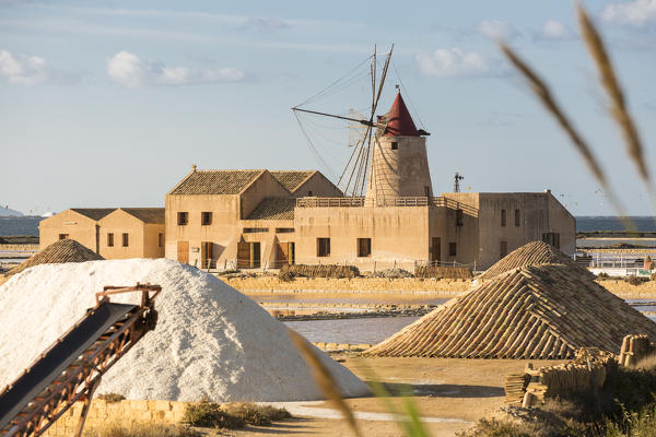 Pyramids of salt in front of Infersa windmill, on the coast connecting Marsala to Trapani, Trapani province,Sicily,Italy