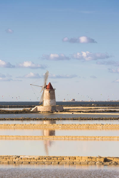 Salt pans with rows of tanks and a fully functional windmill on the coast connecting Marsala to Trapani, Trapani province,Sicily,Italy