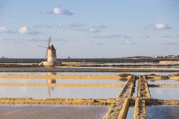 Salt pans with rows of tanks, locks, canals and a fully functional windmill on the coast connecting Marsala to Trapani, Trapani province,Sicily,Italy
