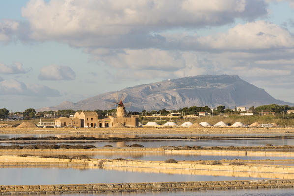 Salt pans in front of Infersa windmill on the coast connecting Marsala to Trapani, Trapani province,Sicily,Italy