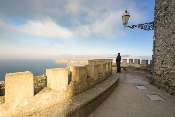 Tourist looking up to panoramic view at Venus castle, Erice, Trapani province, Sicily, Italy