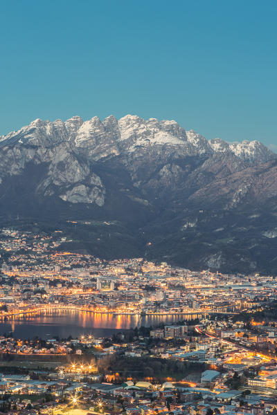 Lecco province at dusk with Resegone mount in the background viewed from San Tomaso, Valmadrera, Lecco province, Lombardy, Italy
