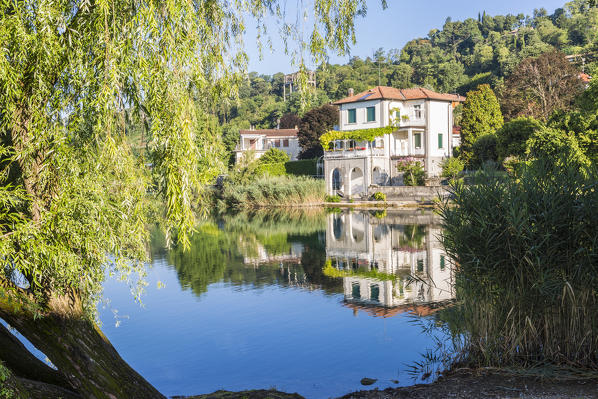 House reflected in the Pusiano lake, Como Province, Lombardy, Italy