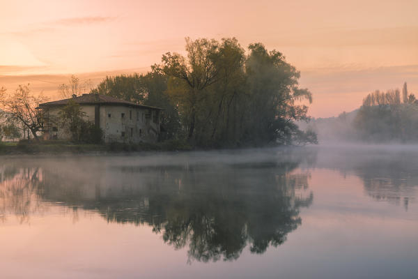 Reflections on Adda river at dawn, Lecco Province, Lombardy, Italy