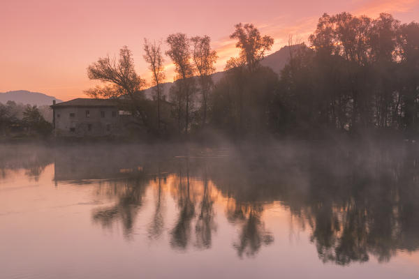 Reflections on Adda river at dawn, Lecco Province, Lombardy, Italy
