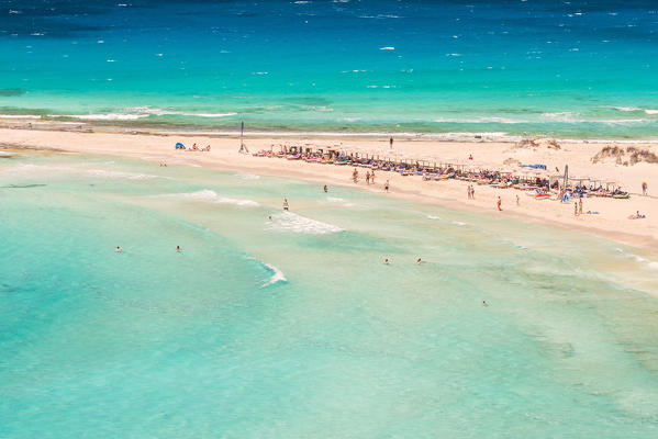 People on the narrow stretch of white sand which divides Simos beach, Elafonissos, Laconia Region, Peloponnese, Greece