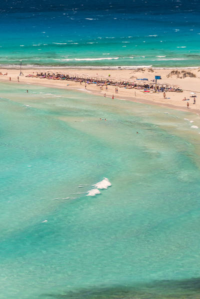 People on the narrow stretch of white sand which divides Simos beach, Elafonissos, Laconia Region, Peloponnese, Greece