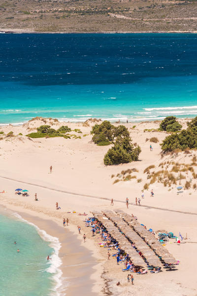 People on the narrow stretch of white sand which divides Simos beach, Elafonissos, Laconia Region, Peloponnese, Greece