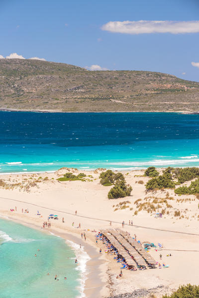 People on the narrow stretch of white sand which divides Simos beach, Elafonissos, Laconia Region, Peloponnese, Greece